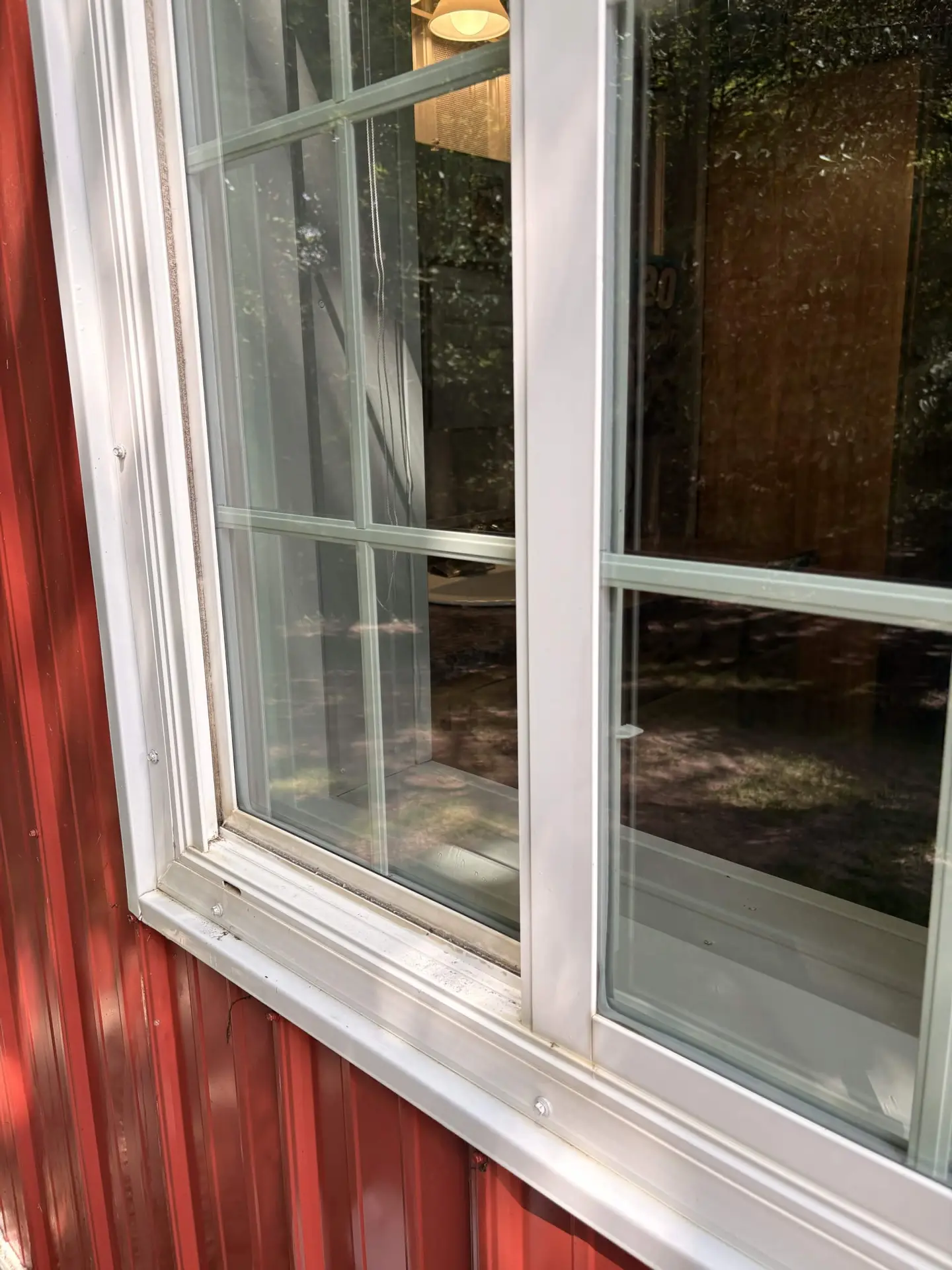 The same window with crystal-clear glass and a spotless sill after cleaning